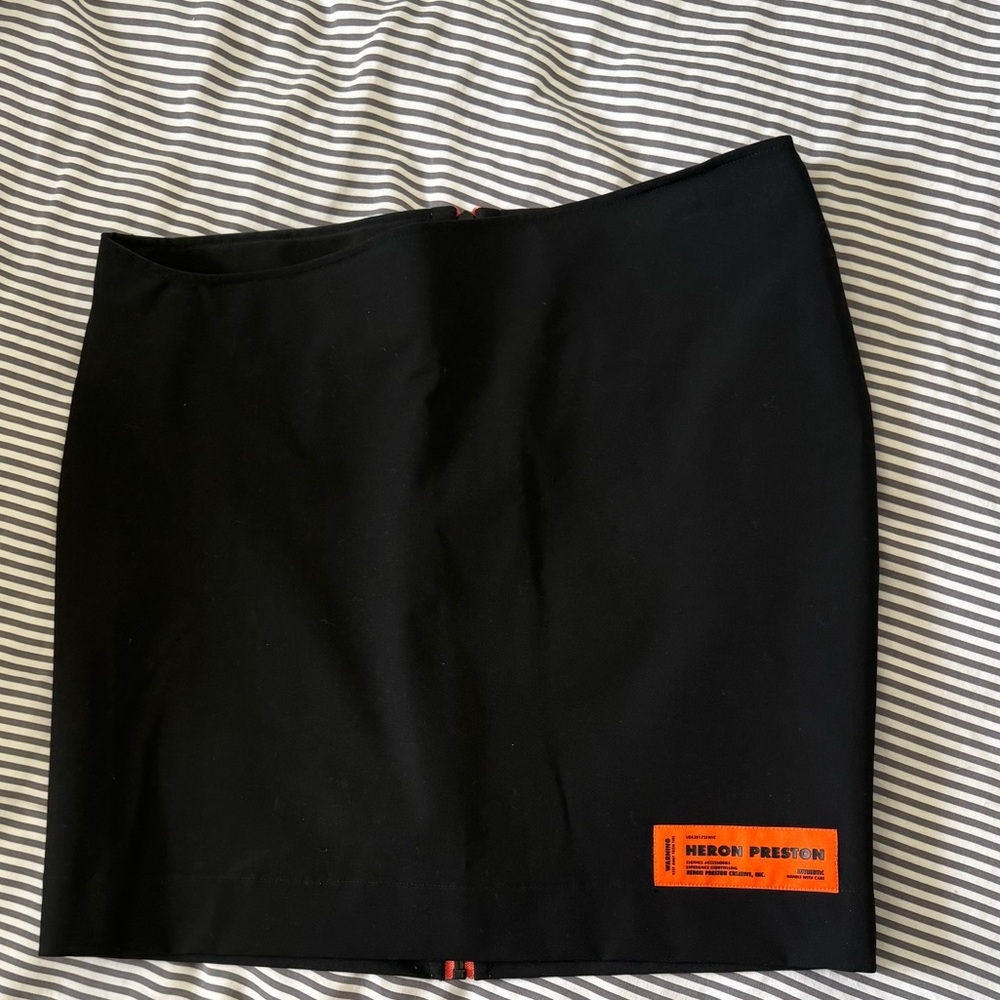 Heron Preston Asymmetric Waist Black Skirt with Orange Logo Patch